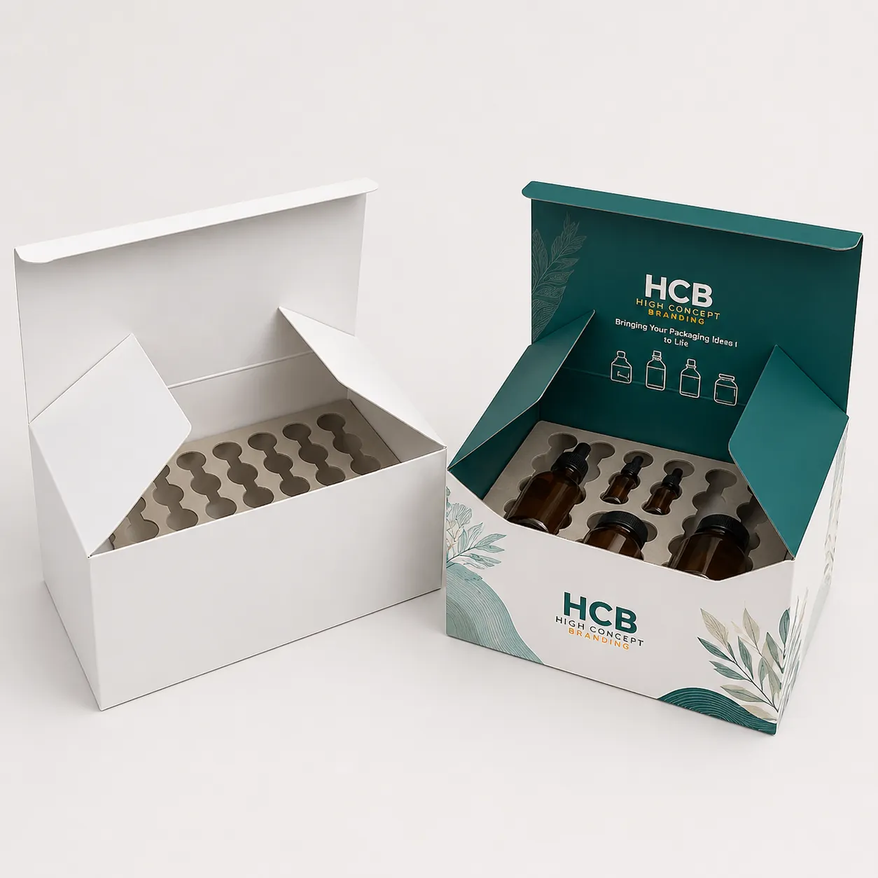 Large white and teal presentation boxes with specialized product inserts designed to securely hold various bottles. class=